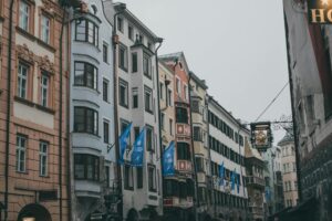 Cobblestone street in a charming, crowd-free European city with historic architecture and colorful buildings.